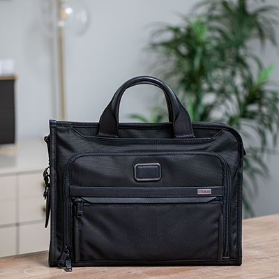TUMI<sup>&reg;</sup> Alpha 3 Slim Deluxe Portfolio - This slim portfolio-style brief is well organized for your business or travel needs.  It features a zip-around opening for easy access to the main compartment. The interior features a padded tablet pocket, multiple pockets for accessories, and a magnetic slip pocket on the front.  Bag measures  12"H x 16"W x 3"D.  Also features removable, padded shoulder strap and leather top carry handles.